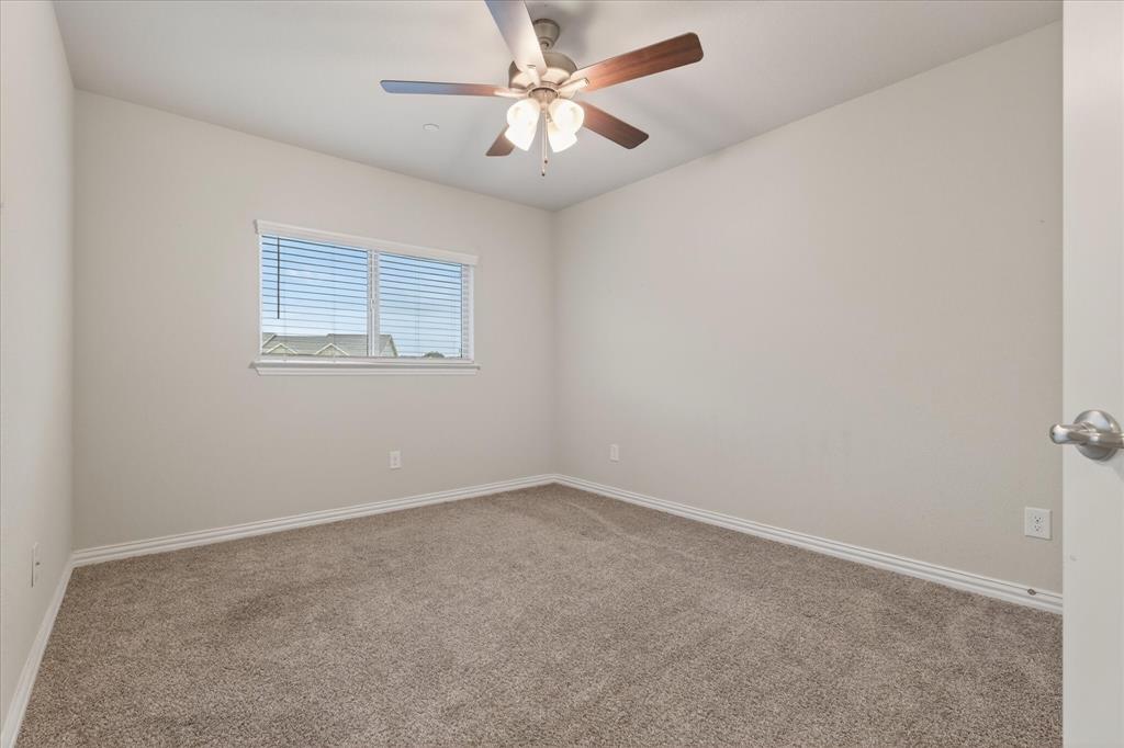 2200 Davenport Drive Denton, TX 76207 - Photo 19 of 23 an empty room with a window and a fan