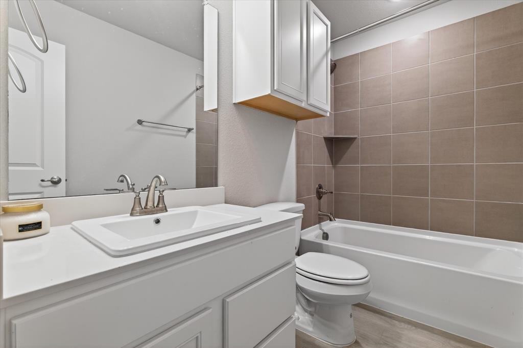 2200 Davenport Drive Denton, TX 76207 - Photo 20 of 23 a bathroom with a sink a toilet and shower