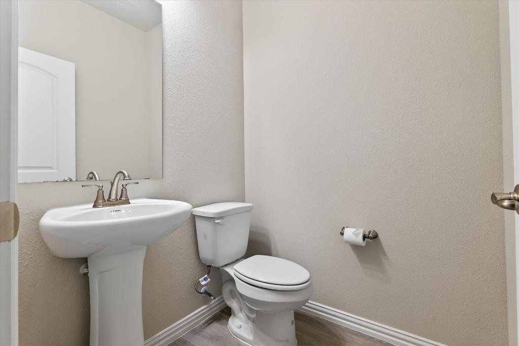2200 Davenport Drive Denton, TX 76207 - Photo 21 of 23 a bathroom with a toilet sink and mirror