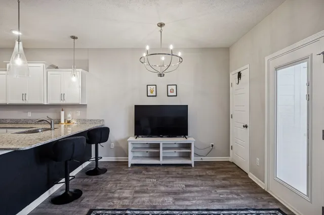 a open kitchen with stainless steel appliances granite countertop a stove and a view of kitchen