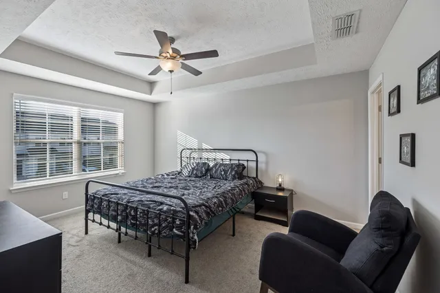 a bedroom with a bed and a chandelier