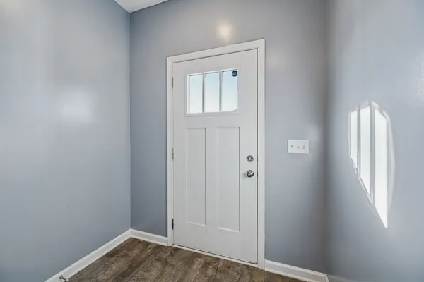 an empty room with windows and closet