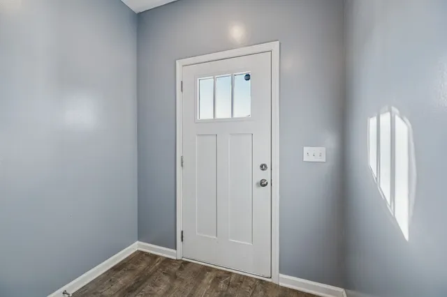 an empty room with windows and closet