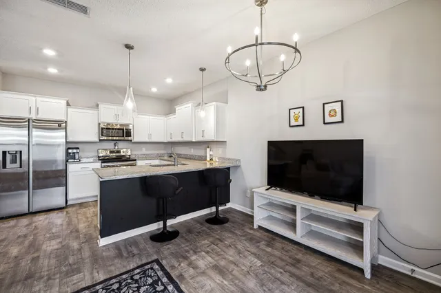 a view of kitchen with sink microwave and refrigerator