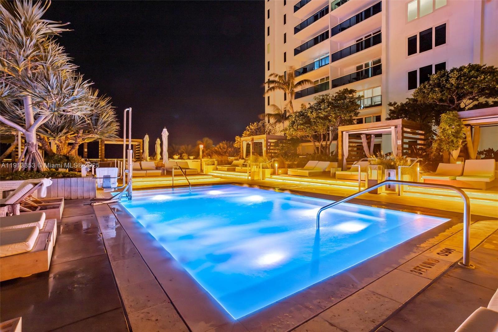2301 Collins Avenue, Unit 1432 Miami Beach, FL 33139 - Photo 12 of 63 a view of a swimming pool with a lounge chairs