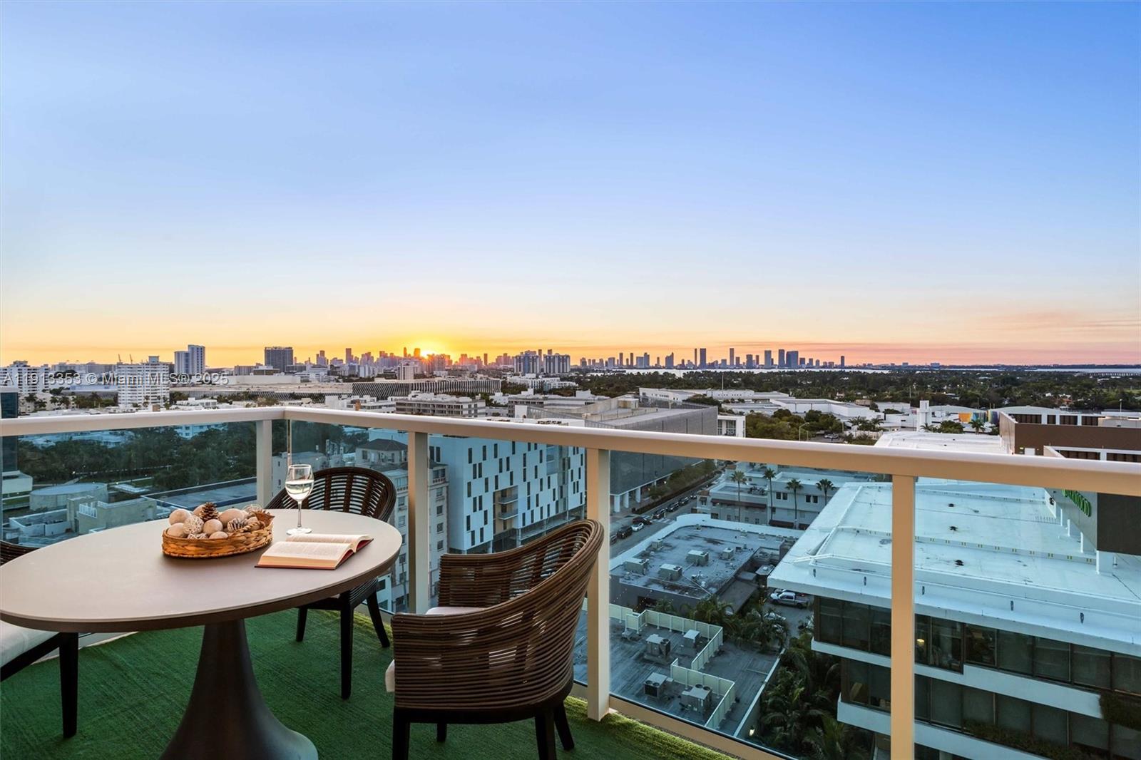 2301 Collins Avenue, Unit 1432 Miami Beach, FL 33139 - Photo 26 of 63 a view of a balcony with a table and chairs
