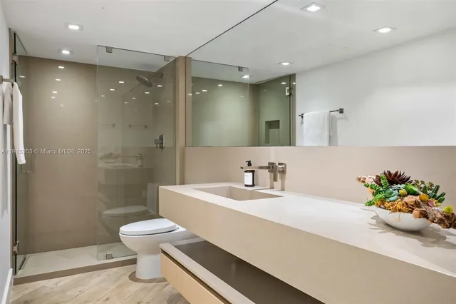 a bedroom with a large bed and a flat screen tv