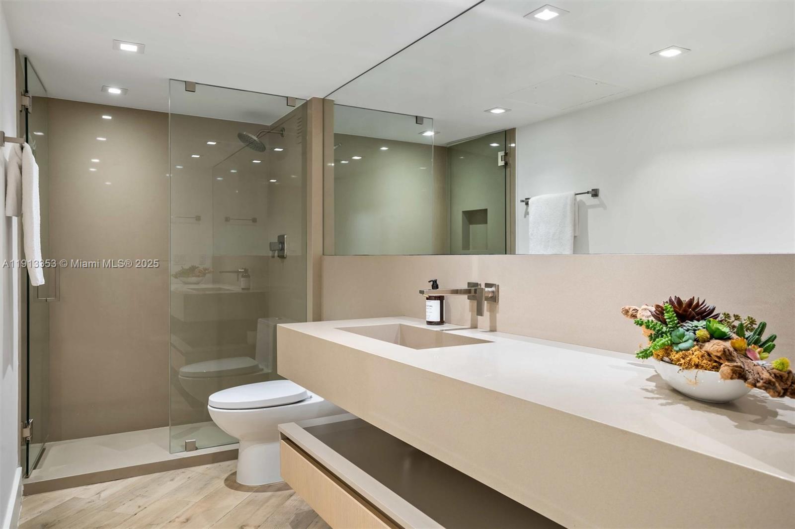 2301 Collins Avenue, Unit 1432 Miami Beach, FL 33139 - Photo 27 of 63 a bathroom with a sink a toilet and a shower