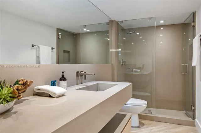 a kitchen with kitchen island a counter top space cabinets and stainless steel appliances