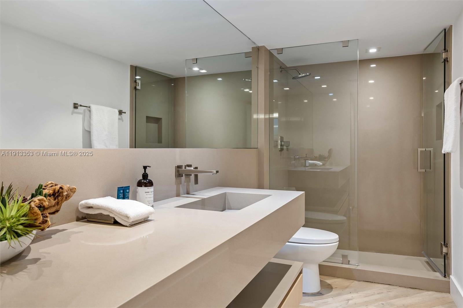 2301 Collins Avenue, Unit 1432 Miami Beach, FL 33139 - Photo 30 of 63 a bathroom with a sink a toilet and shower