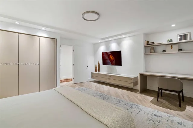 a kitchen with a table chairs microwave and cabinets