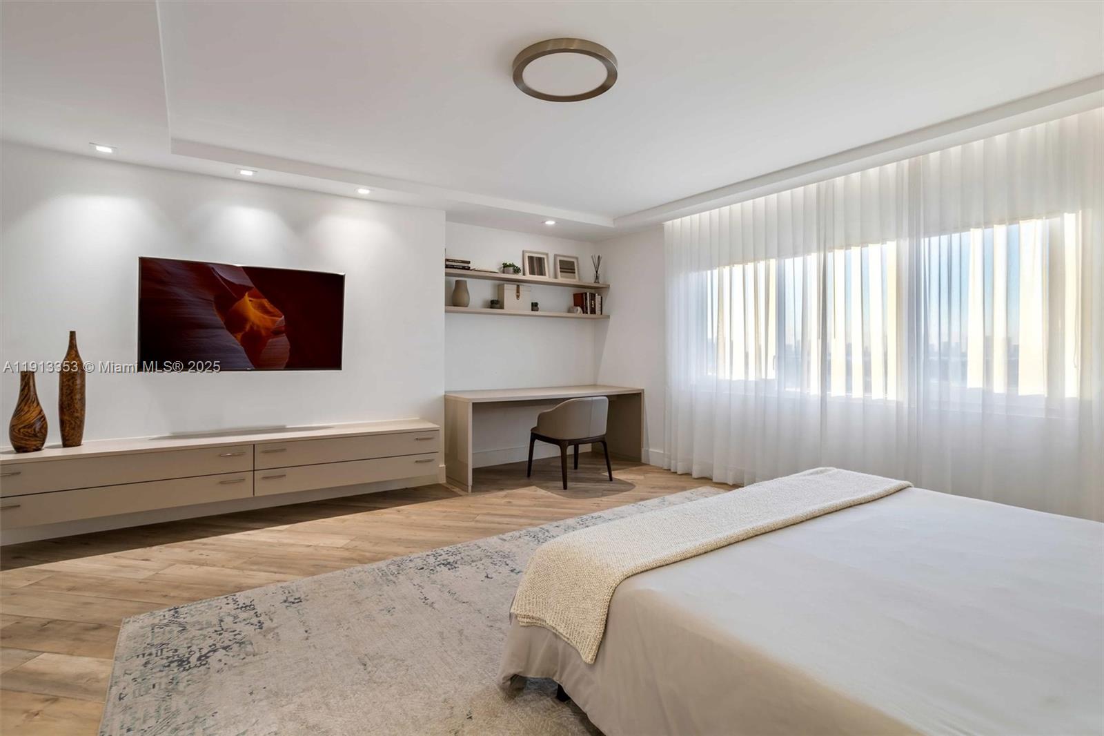 2301 Collins Avenue, Unit 1432 Miami Beach, FL 33139 - Photo 33 of 63 a bedroom with a bed and a flat screen tv