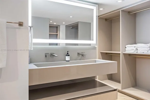 a kitchen with stainless steel appliances kitchen island granite countertop a refrigerator and a stove