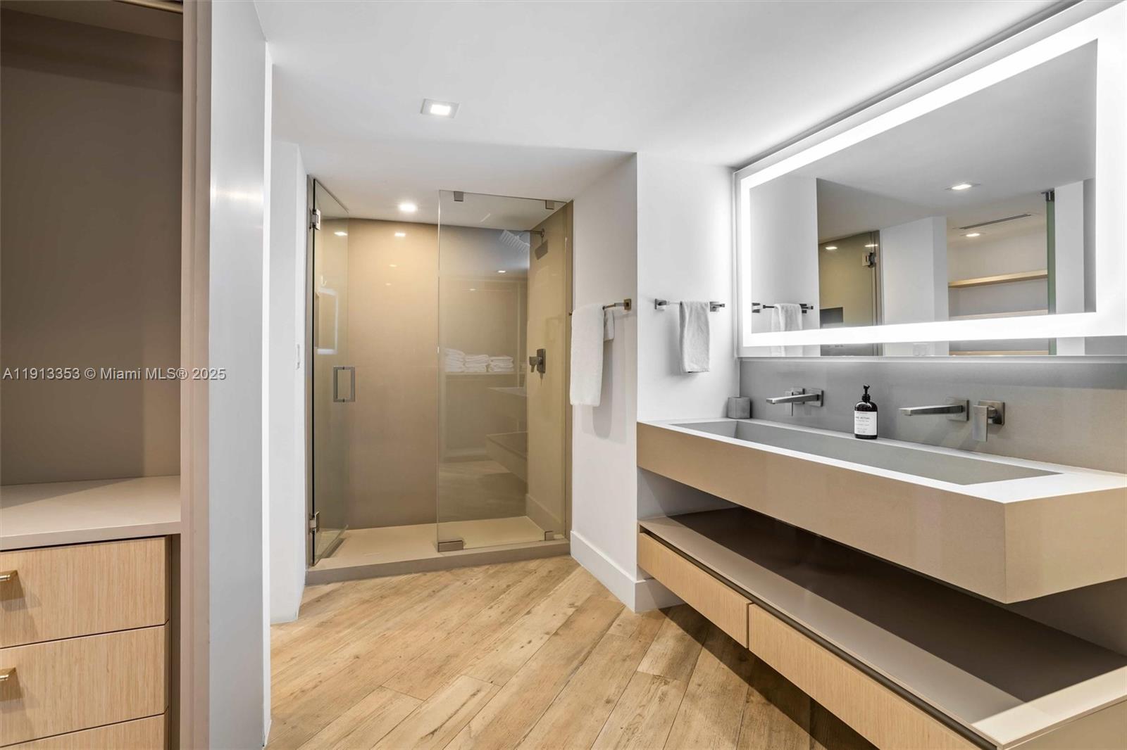 2301 Collins Avenue, Unit 1432 Miami Beach, FL 33139 - Photo 36 of 63 a bathroom with a double vanity sink mirror and shower