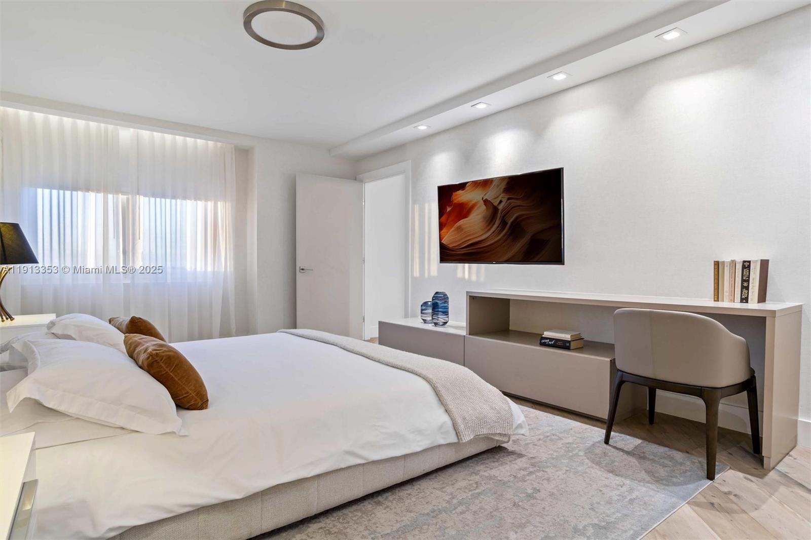 2301 Collins Avenue, Unit 1432 Miami Beach, FL 33139 - Photo 37 of 63 a bedroom with a large bed and a flat screen tv