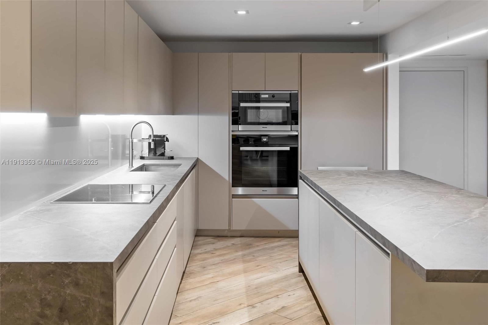 2301 Collins Avenue, Unit 1432 Miami Beach, FL 33139 - Photo 39 of 63 a kitchen with stainless steel appliances granite countertop a sink and a stove