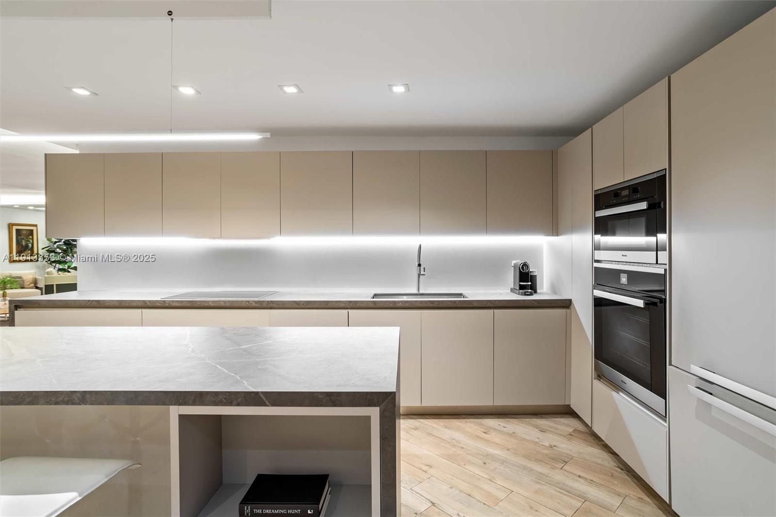 2301 Collins Avenue, Unit 1432 Miami Beach, FL 33139 - Photo 40 of 63 a kitchen with kitchen island a counter top space cabinets and stainless steel appliances
