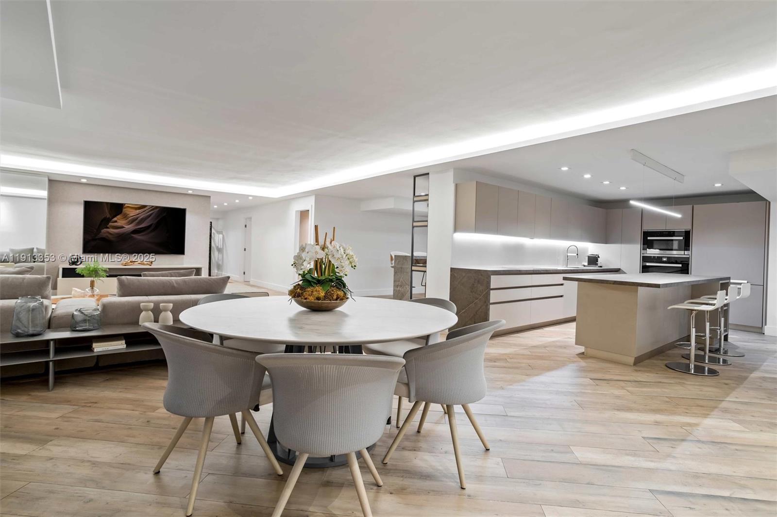 2301 Collins Avenue, Unit 1432 Miami Beach, FL 33139 - Photo 52 of 63 a kitchen with a table and chairs in it