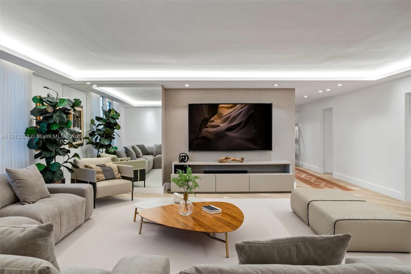 2301 Collins Avenue, Unit 1432 Miami Beach, FL 33139 - Photo 56 of 63 a living room with furniture and a flat screen tv