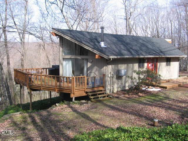a view of a house with backyard and wooden fence