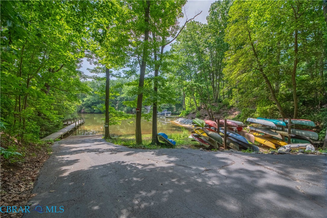 54 Villa Ridge Drive, Unit C Hartfield, VA 23071 - Photo 17 of 45 View of asphalt road featuring a boat ramp and a water view