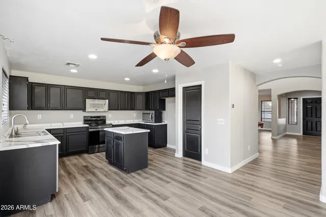 a kitchen with a sink and a stove top oven