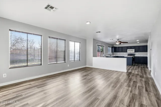 a view of wooden floor and a kitchen