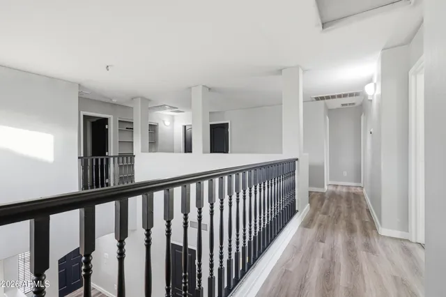 a view of a hallway view with wooden floor and staircase