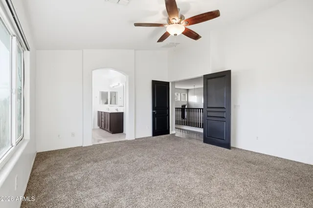 a view of a kitchen with a sink and a refrigerator