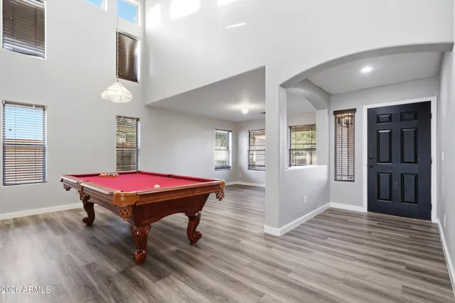a room with pool table and windows