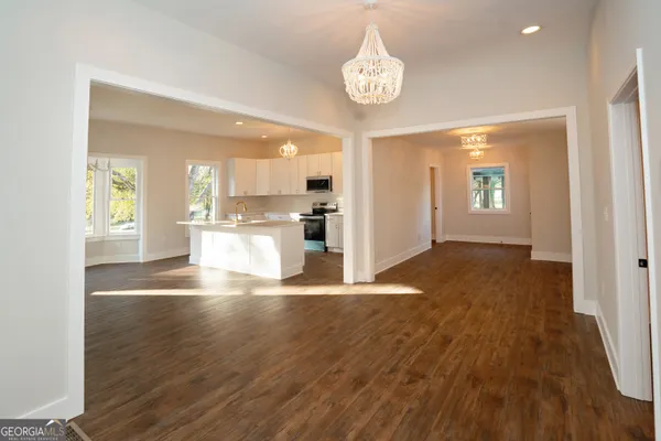 a kitchen with a sink cabinets and wooden floor