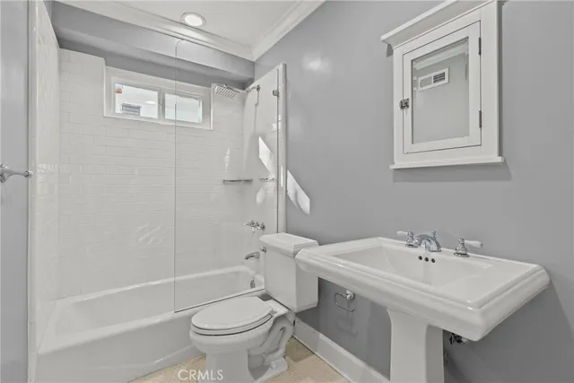a bathroom with a sink a toilet and a bathtub