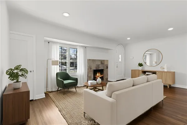 a living room with furniture fireplace and a potted plant