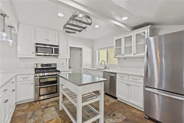 a kitchen with a refrigerator stove and sink