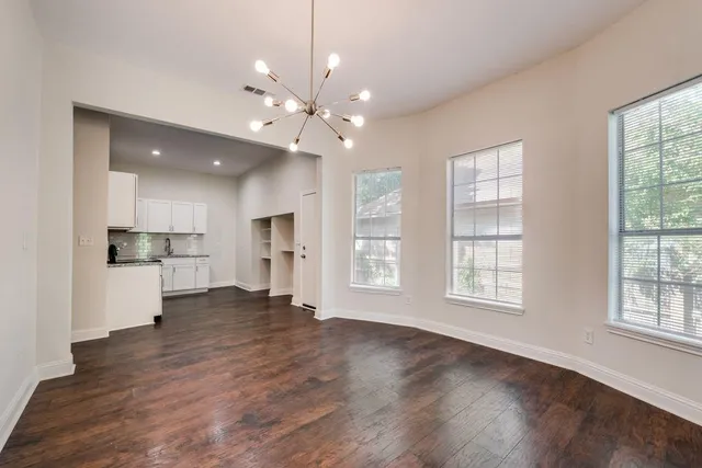 a kitchen with a stove and white cabinets