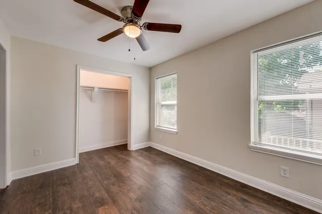 a bathroom with a granite countertop sink a toilet and shower