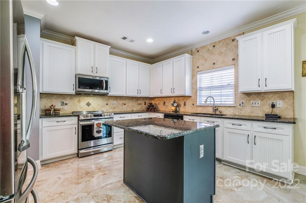14410 Winged Teal Road Charlotte, NC 28278 - Photo 11 of 38 a kitchen with cabinets appliances a sink and a window