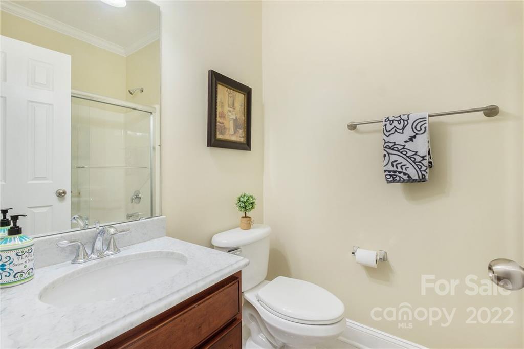 14410 Winged Teal Road Charlotte, NC 28278 - Photo 18 of 38 a bathroom with a granite countertop sink mirror vanity and toilet