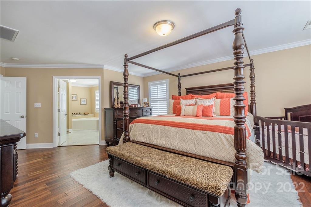 14410 Winged Teal Road Charlotte, NC 28278 - Photo 23 of 38 a bedroom with a bed and wooden floor