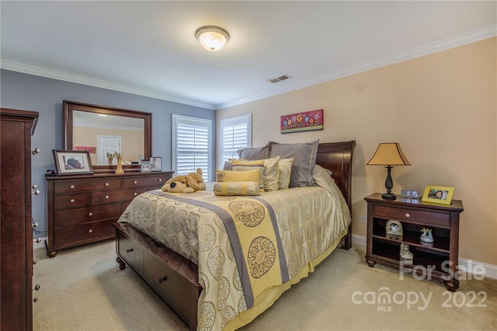 14410 Winged Teal Road Charlotte, NC 28278 - Photo 26 of 38 a spacious bedroom with a bed and dresser