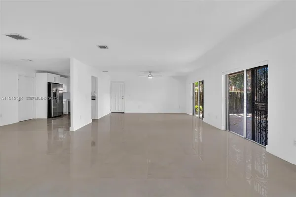 an empty room with a empty space and windows
