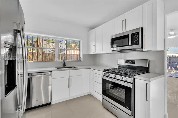 a kitchen with a sink stainless steel appliances and cabinets