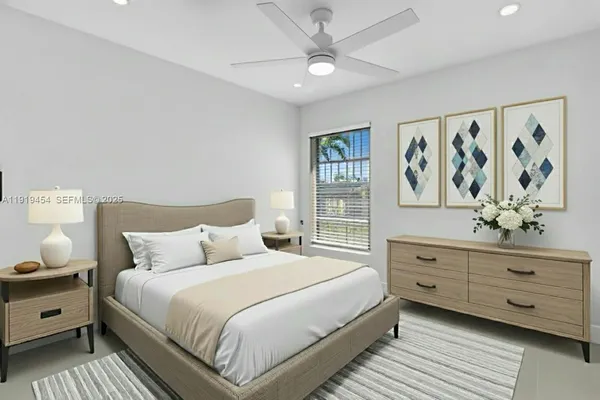 an empty room with a window and a ceiling fan