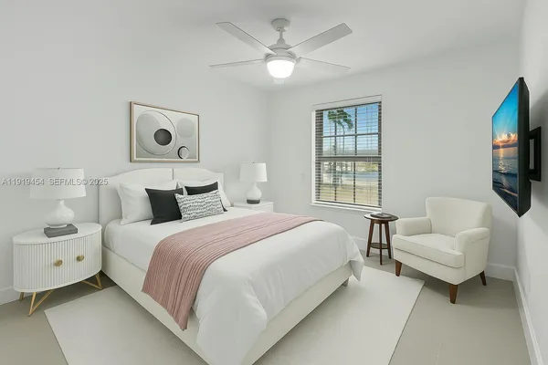 an empty room with a ceiling fan and a window