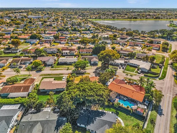 an aerial view of a house with garden space and street view