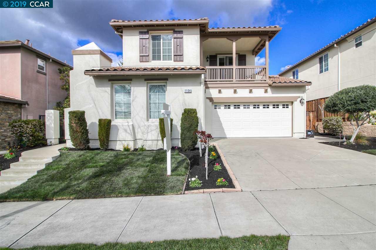 a view of a white house with a patio and a yard