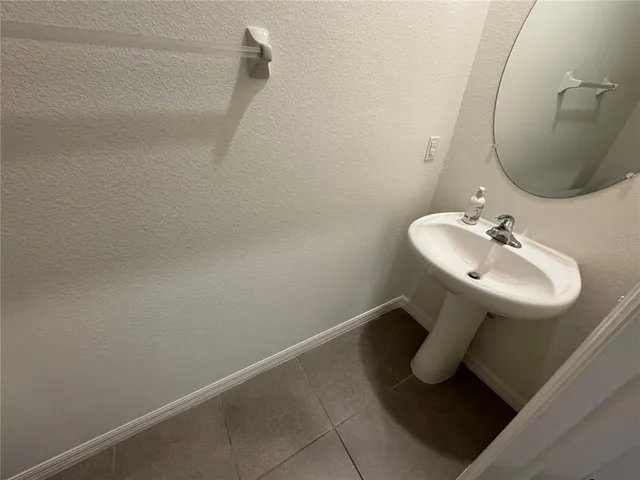 a bathroom with a sink and mirror