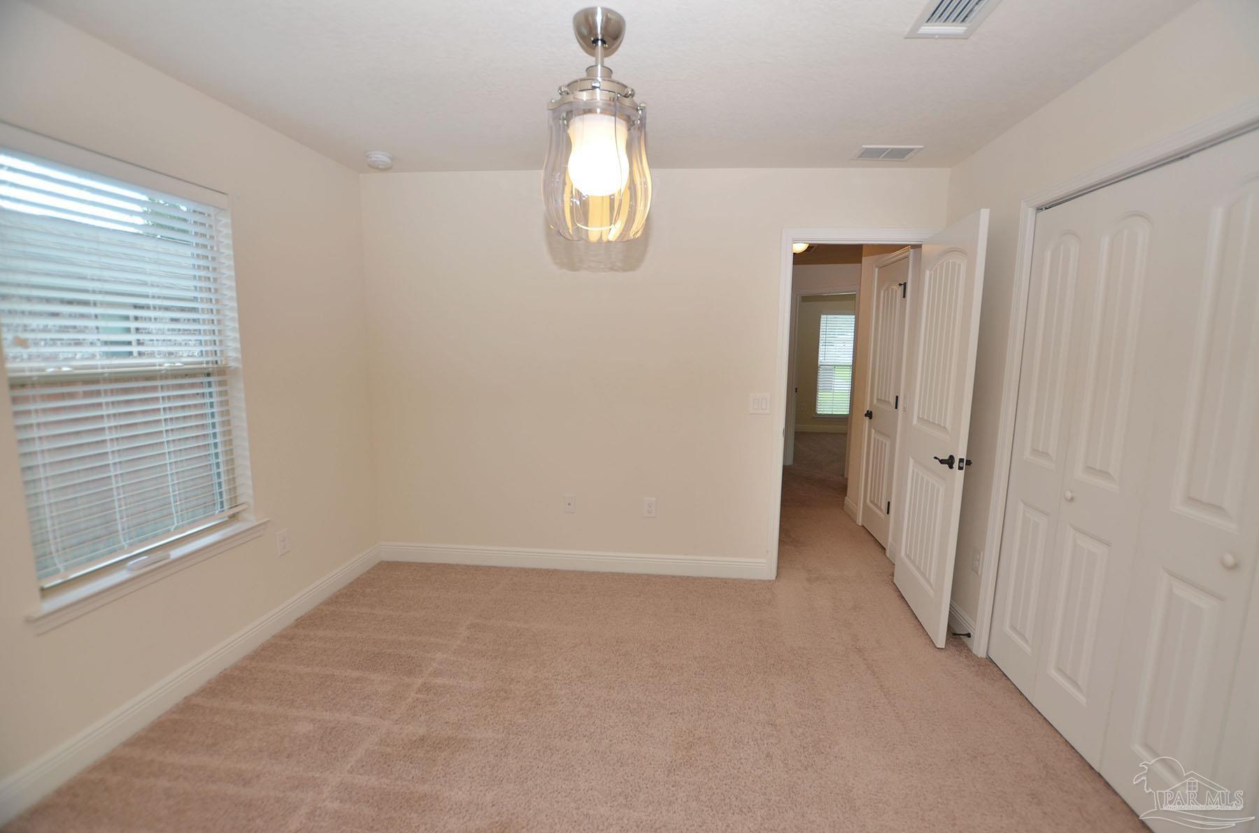 5709 Mill Stream Way Pace, FL 32571 - Photo 32 of 48 a view of an empty room with a window