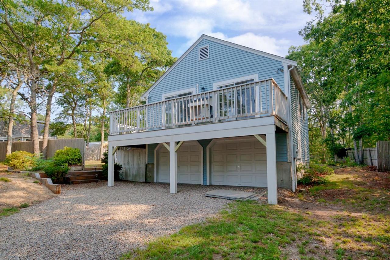 a view of a house with a yard and large tree