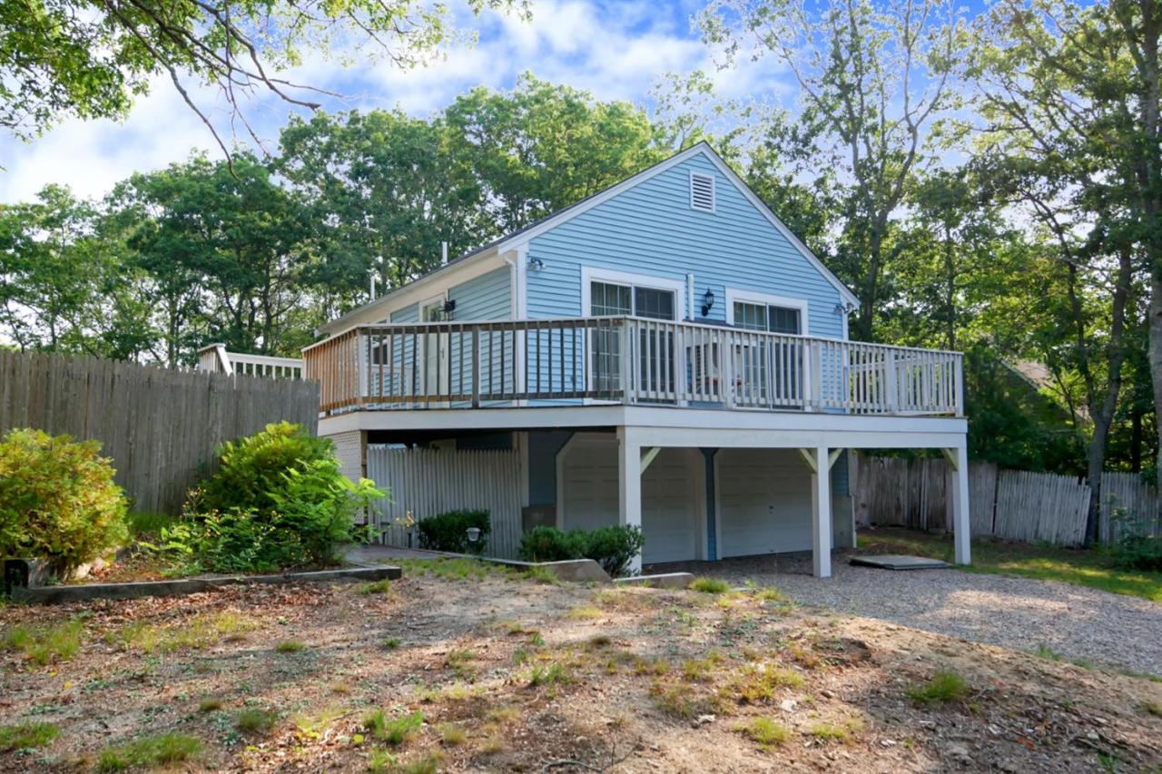 12 Santuit Pond Road Mashpee, MA 02649 - Photo 2 of 31 a view of a house with a yard and plants